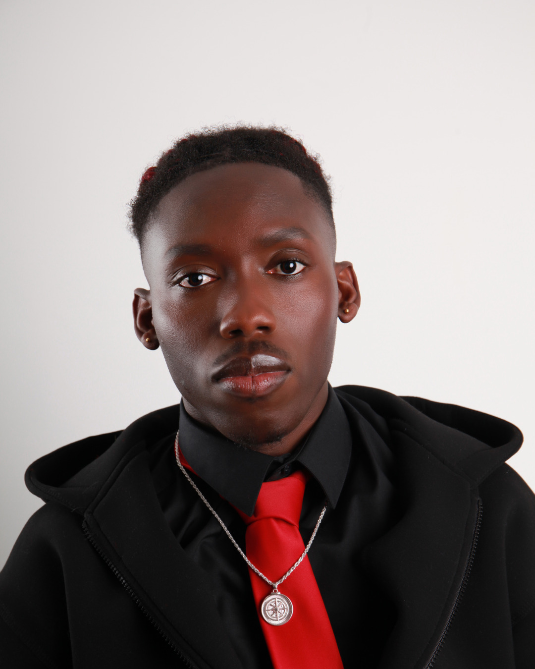 Felix, founder of Rogue Fashion, in a red tie and black coat