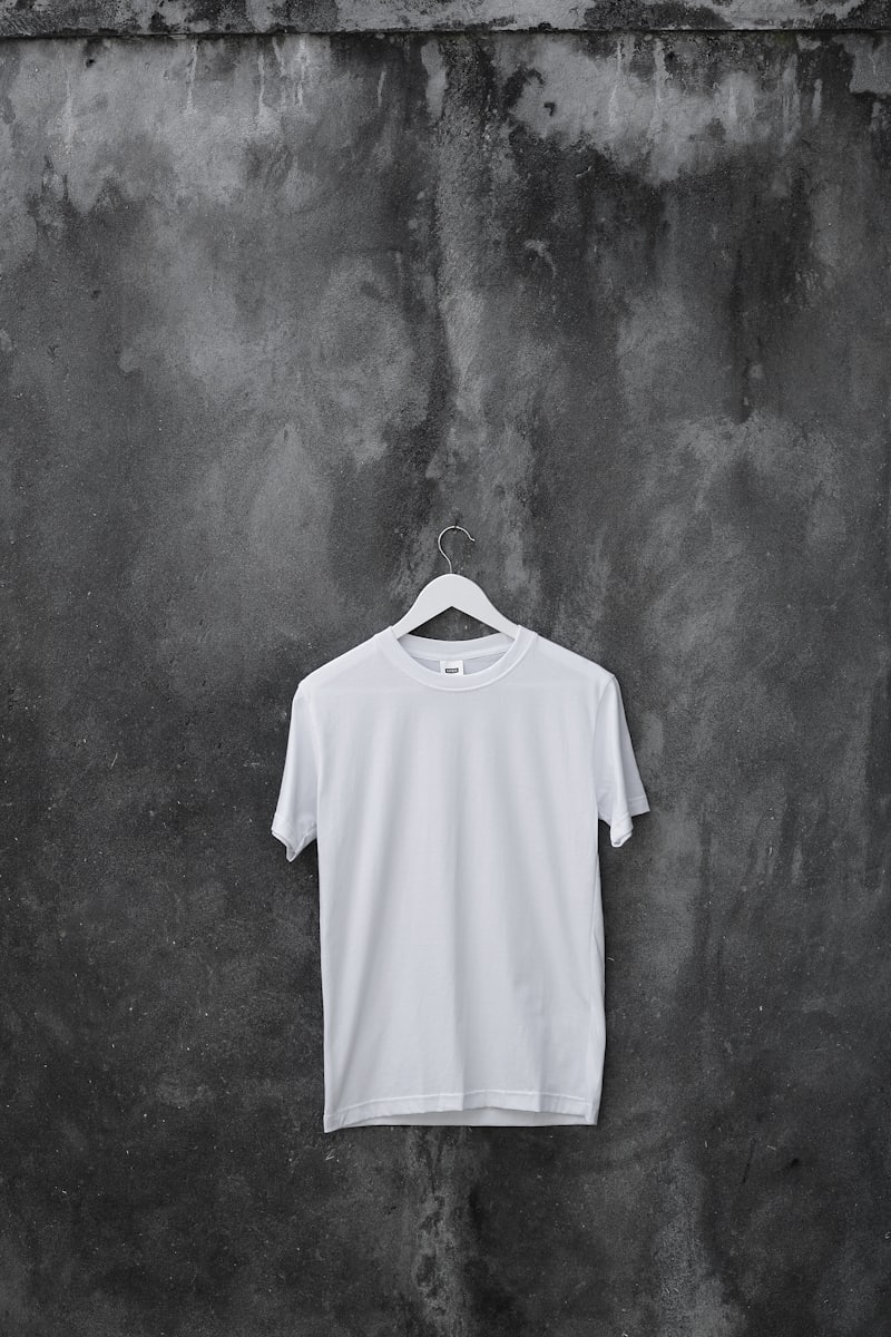 A plain white boxy tee on a hanger