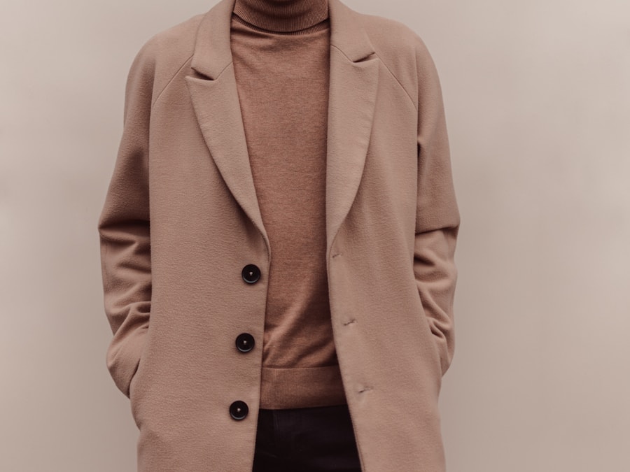 A camel wool overcoat worn over a roll neck
