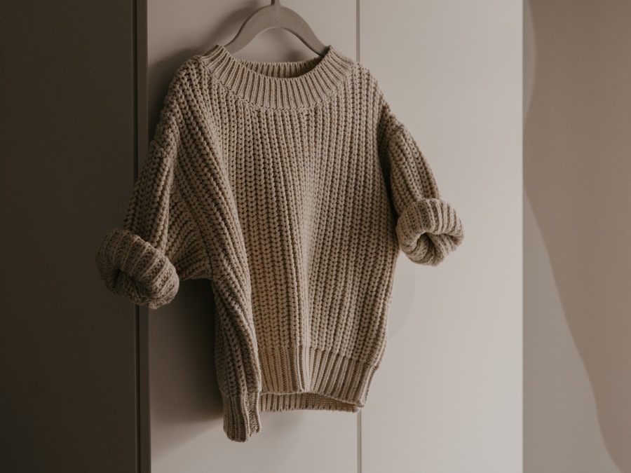 A cream fine-knit jumper on a hanger