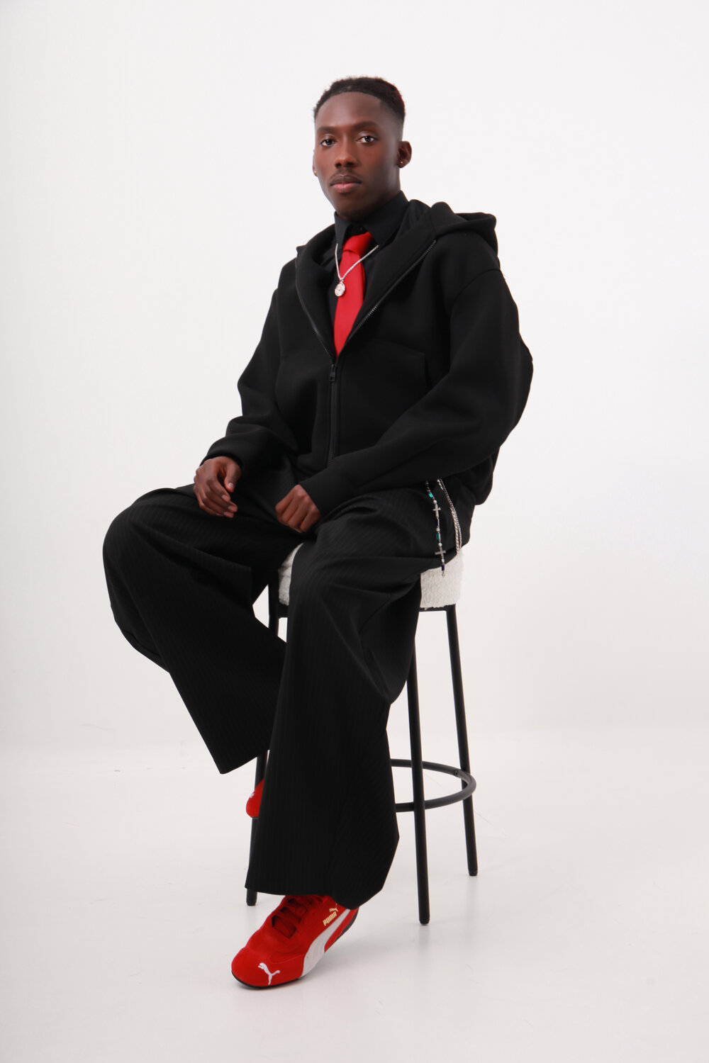 Statement outfit: black tailoring with a hit of red