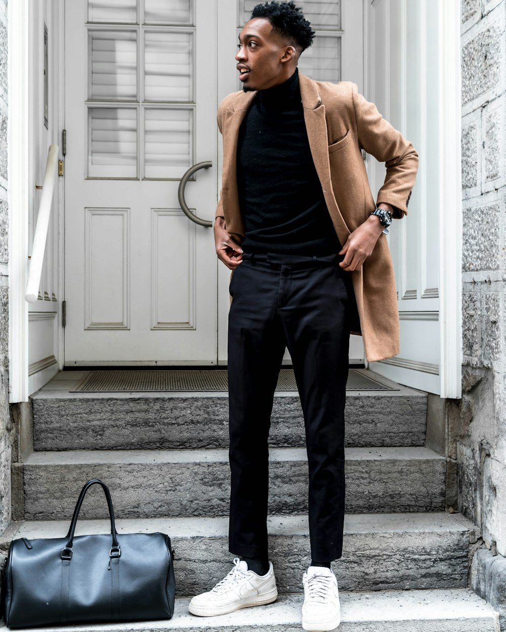 Minimalist outfit: all black under a camel coat